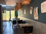 tables and chairs are lined up in a long hallway with posters on the wall
