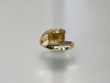 an image of a yellow sapphire and diamond ring on a white surface