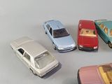several toy cars are lined up in a circle on a white surface