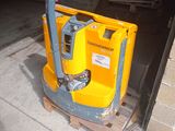 a yellow machine that is sitting on a pallet