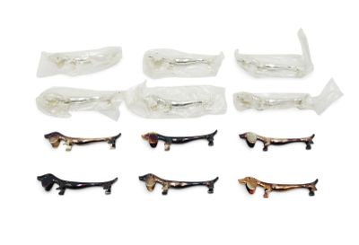 a lot of small plastic dachshunds on a white surface