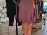 a display of clothes on a clothes rack in a clothing store