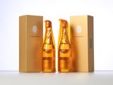 two bottles of champagne sitting next to each other in front of a box