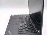 a laptop with a black keyboard on a white surface