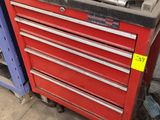 a red tool cabinet with a lot of tools on it