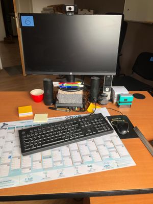 a desk with a keyboard, mouse and a monitor on it