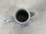 a cup of coffee sitting on a table next to a plate of food