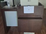 a small desk with a laptop on it in the middle of a room