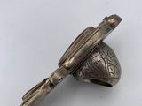 an old silver bell with a bird on it