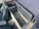 an image of a car with a seat and storage compartment