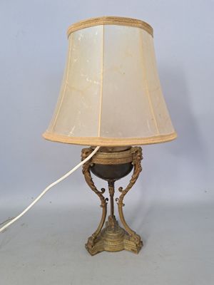 a lamp that is sitting on a table with a lamp shade on it
