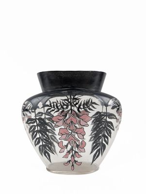 a black and white vase with pink flowers on it
