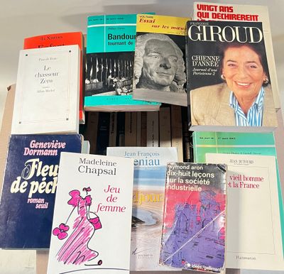 many books that are on a shelf in a room