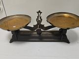 a pair of brass scales on a white table