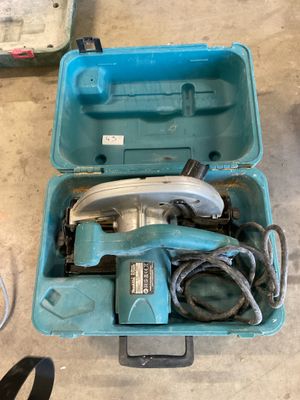 a blue box with tools in it sitting on the floor