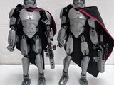 two star wars action figures standing next to each other