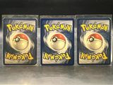 three packs of pokemon cards are on display in a store