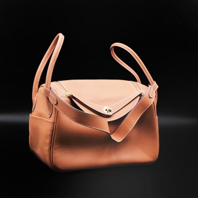 a tan purse with a zipper on the front