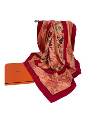 une image représentant une écharpe rouge et rose et une boîte orange