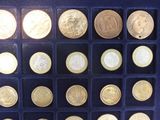 a lot of coins that are in a display case