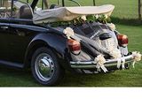 a black vw buggy parked in the grass