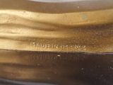 an image of a close up of a gold statue on a table