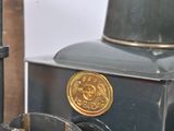 a black and gold clock sitting on top of a wooden table