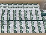a cardboard box filled with lots of green tea packets