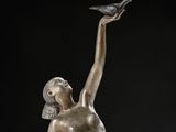 bronze statue of a woman holding a bird on her arm