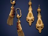 three pairs of gold earrings with garnets and garnets on them