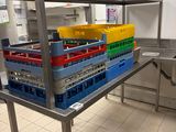 a metal table with crates on it in a kitchen