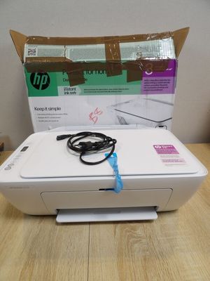 the printer is sitting on the table next to the box