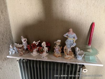 many figurines sitting on a shelf next to a radiator