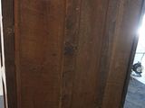 a wooden cabinet that is sitting in a room