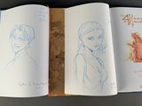 an open book with a drawing of a woman and a picture of a man