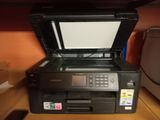 a printer sitting on top of a desk next to a printer