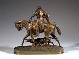 bronze statue of a man on a horse with a dog