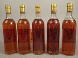four bottles of wine are lined up in a row