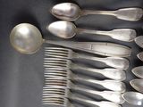 a lot of silver spoons and spoon spoons on a table