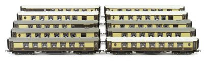 two trains that are sitting side by side on the tracks