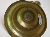 a gold candle holder on a white table