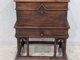 an old wooden table with a drawer on top of it next to a wall