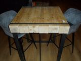 a wooden table with four blue chairs around it