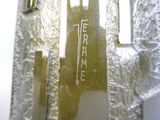 a close up of a metal object with a building in the background