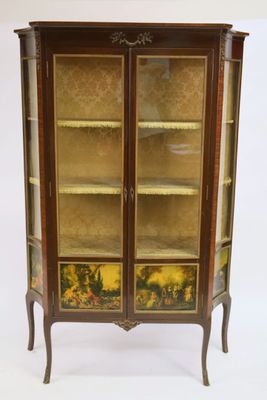 an antique display cabinet with two glass doors and a floral design on the front