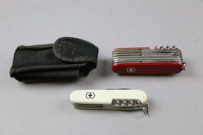 a swiss army knife and a wallet on a table