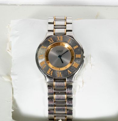a silver and gold watch with roman numerals on it