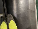 a pair of yellow gloves that are on top of a stove
