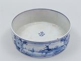 a blue and white bowl sitting on a white surface