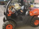 an orange and black fork truck parked on the side of the road